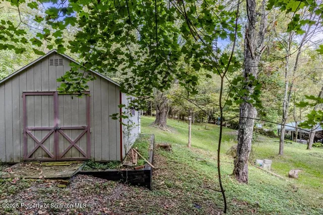 a view of a house with a backyard and sitting area