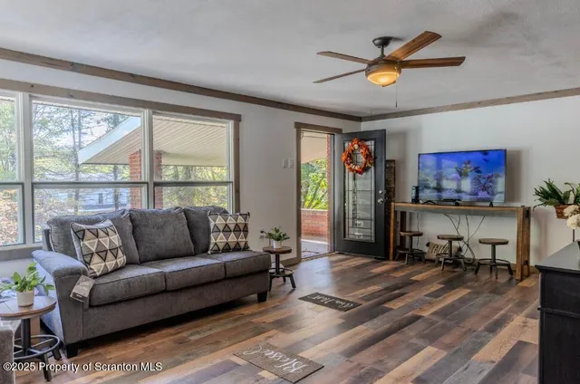 a living room with furniture and a large window