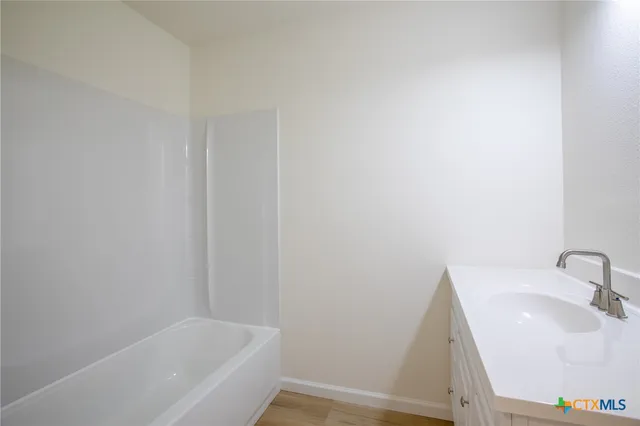 a bathroom with a sink and bathtub