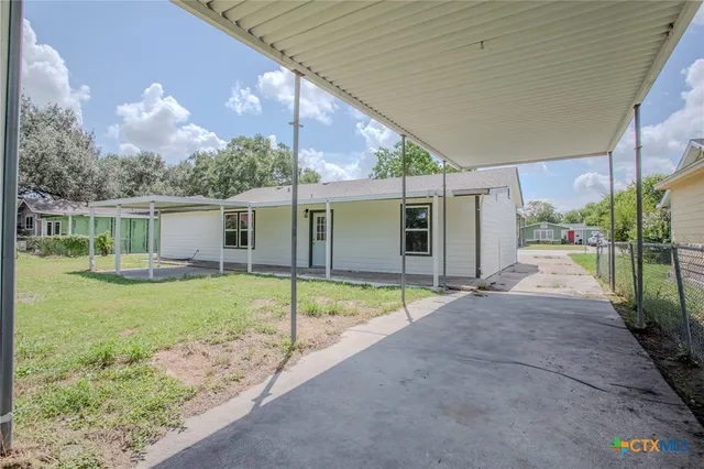 a view of backyard with patio