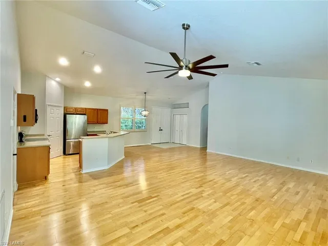a kitchen with stainless steel appliances a stove a sink and a refrigerator