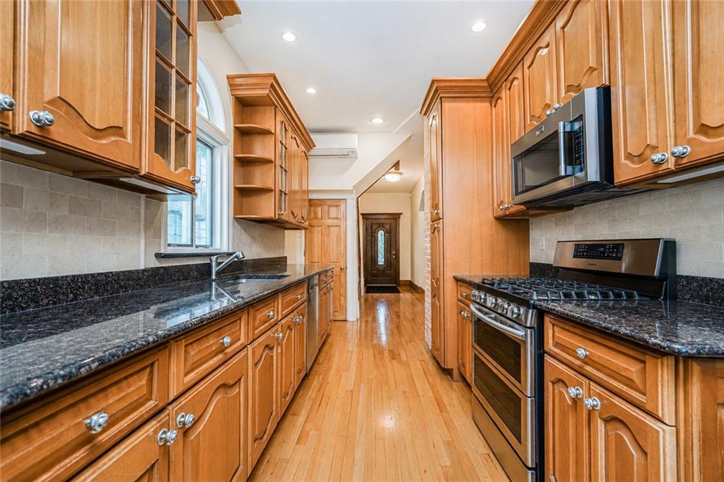 1352 Bay Ridge Parkway Brooklyn, NY 11228 - Photo 18 of 42 a kitchen with stainless steel appliances granite countertop a stove a sink and a microwave