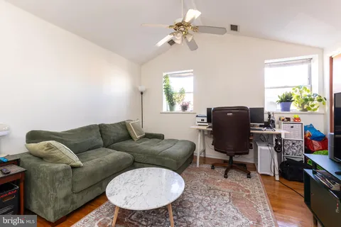 a living room with furniture a chandelier and a window