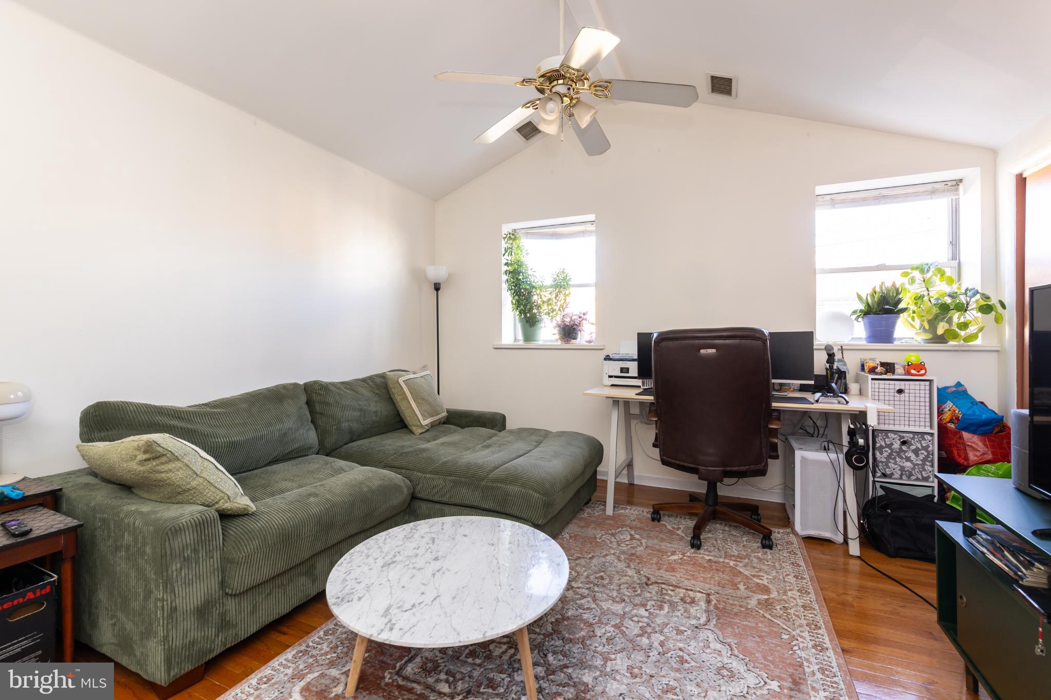 910 Mountain Street Philadelphia, PA 19148 - Photo 11 of 26 a living room with furniture a chandelier and a window