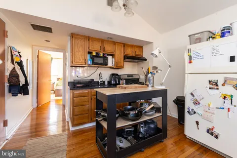 a kitchen with stainless steel appliances a stove a refrigerator and a refrigerator
