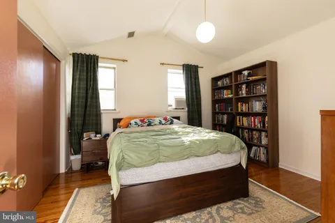 a bedroom with a large bed and a book shelf