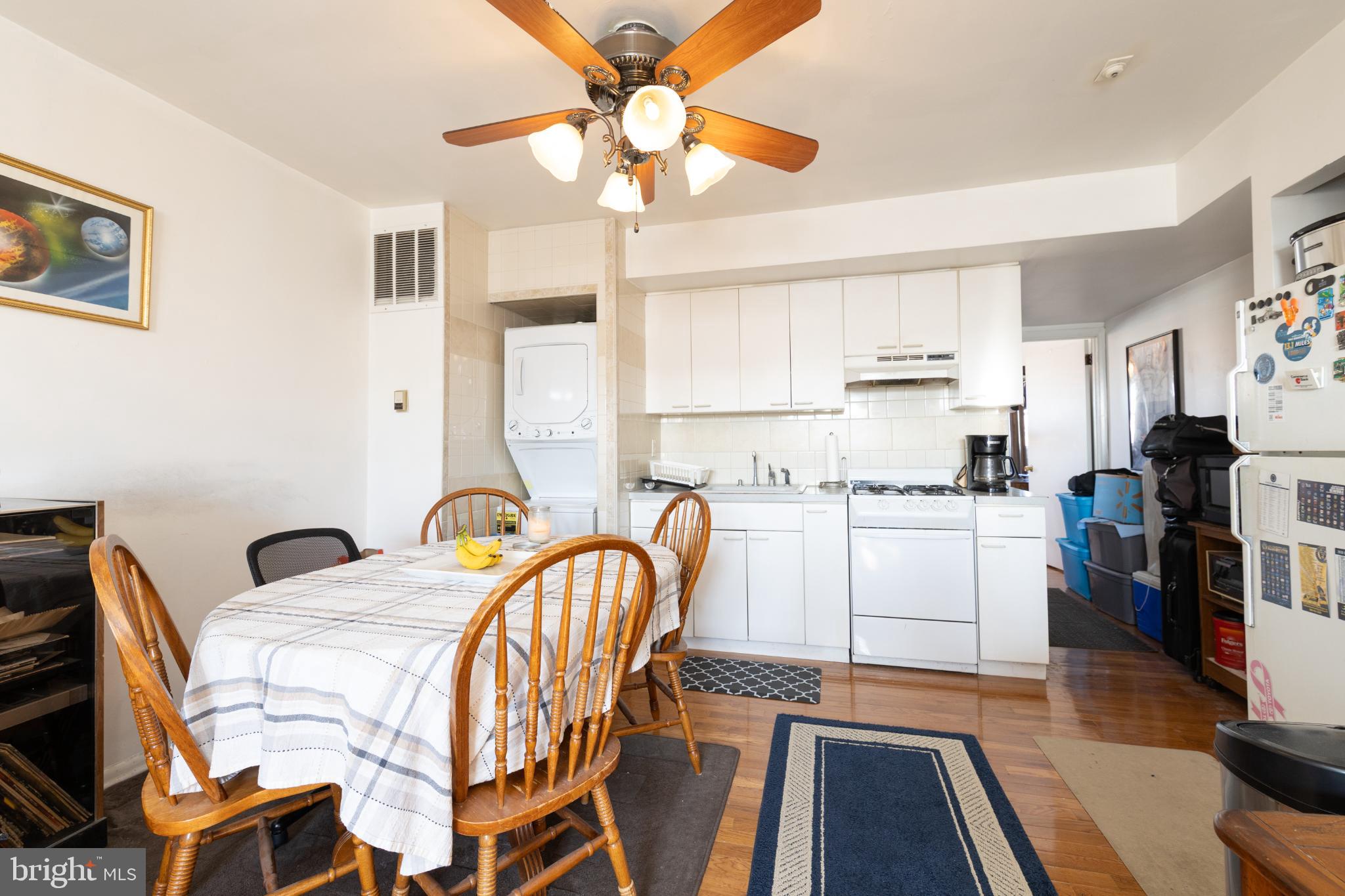 910 Mountain Street Philadelphia, PA 19148 - Photo 20 of 26 a kitchen with a refrigerator and a chandelier