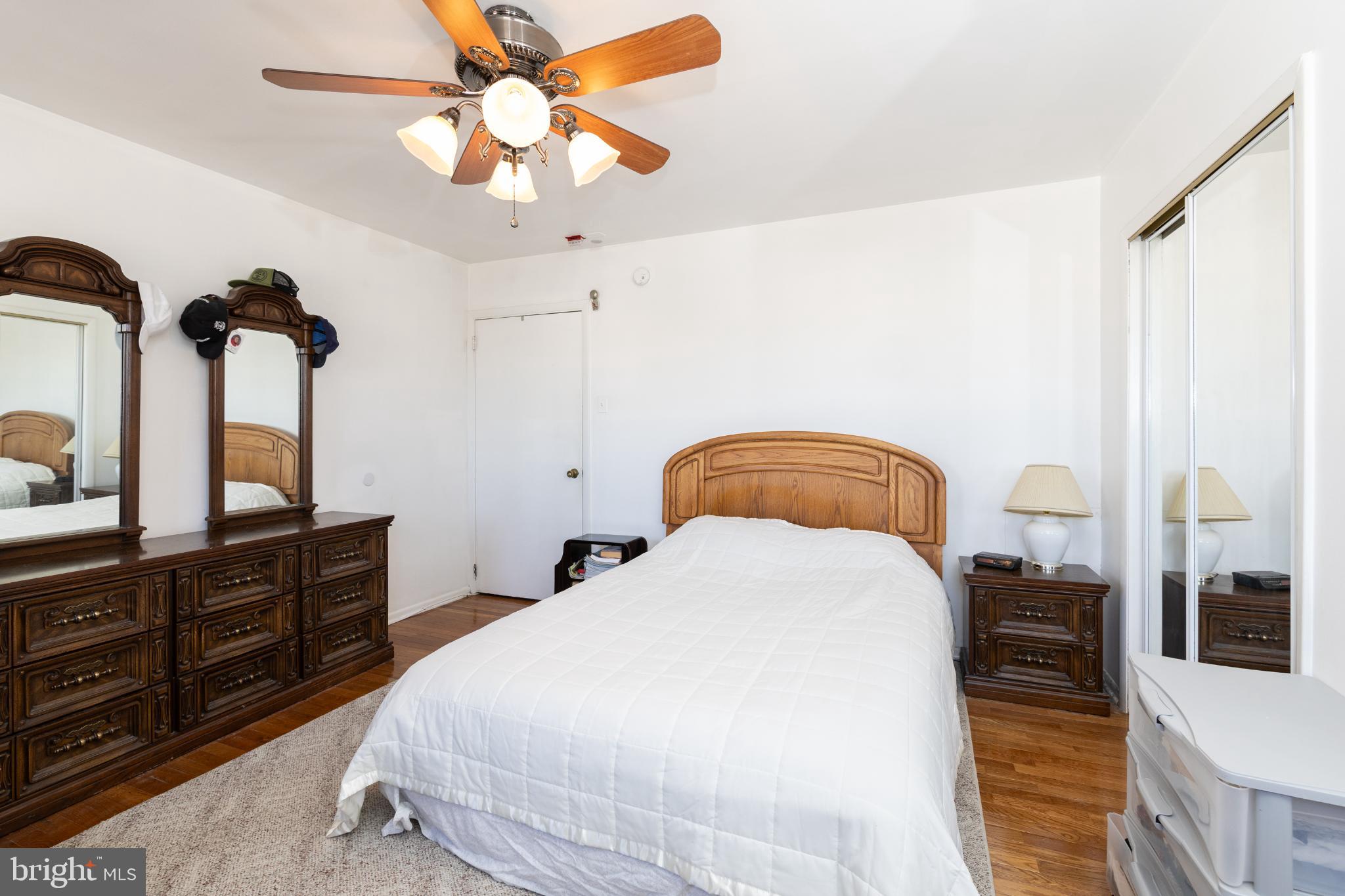 910 Mountain Street Philadelphia, PA 19148 - Photo 24 of 26 a bedroom with a bed and a chandelier