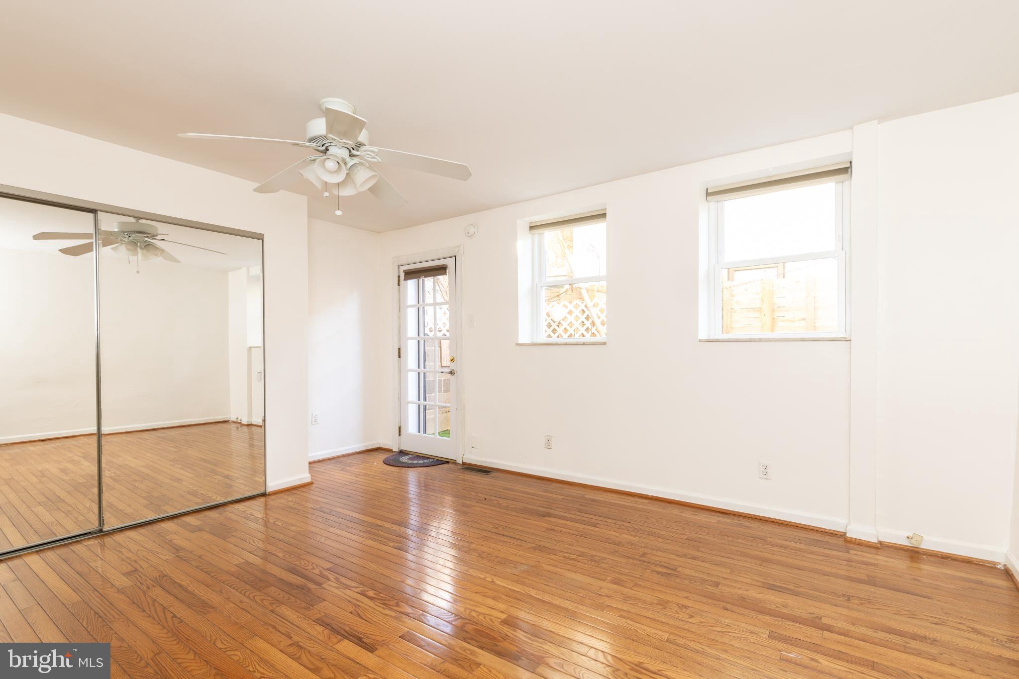 910 Mountain Street Philadelphia, PA 19148 - Photo 9 of 26 an empty room with wooden floor fan and windows