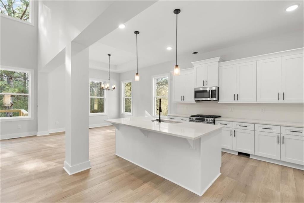 30 Rushden Way Southeast Rome, GA 30161 - Photo 16 of 58 a large kitchen with stainless steel appliances kitchen island granite countertop a stove a sink and white cabinets