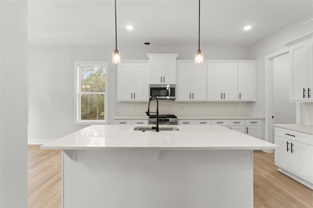 30 Rushden Way Southeast Rome, GA 30161 - Photo 18 of 58 a view of a kitchen with kitchen island a sink stainless steel appliances and cabinets
