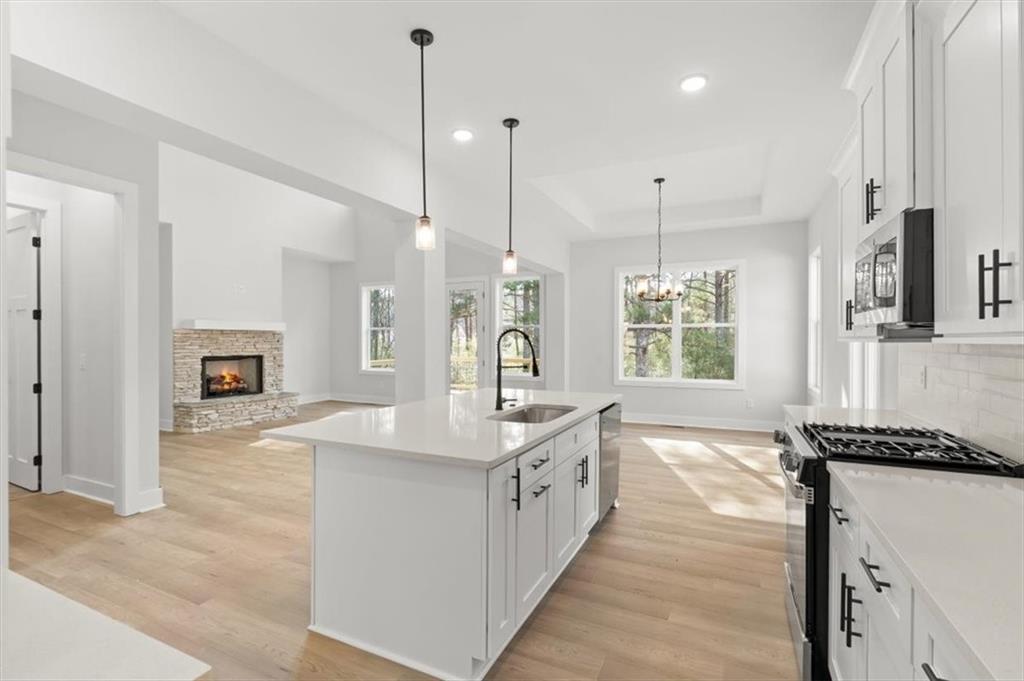 30 Rushden Way Southeast Rome, GA 30161 - Photo 21 of 58 a large kitchen with kitchen island a stove a sink a center island and windows
