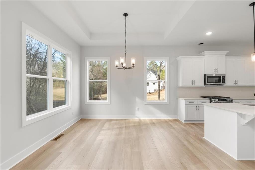 30 Rushden Way Southeast Rome, GA 30161 - Photo 22 of 58 a kitchen with kitchen island granite countertop a stove a sink dishwasher a refrigerator and a wooden floor
