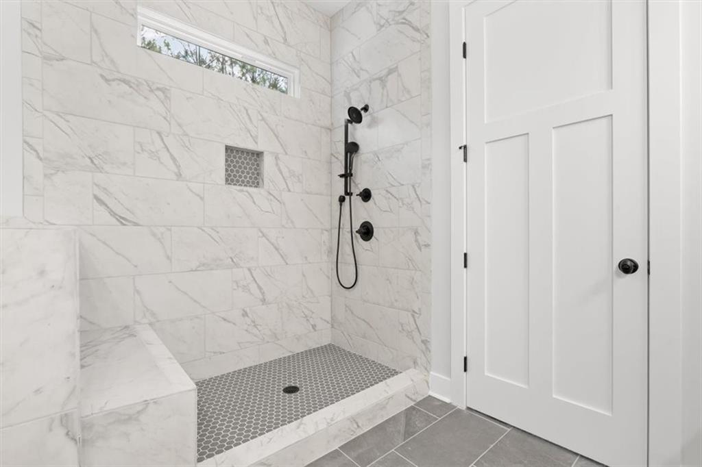30 Rushden Way Southeast Rome, GA 30161 - Photo 28 of 58 a bathroom with a glass shower door