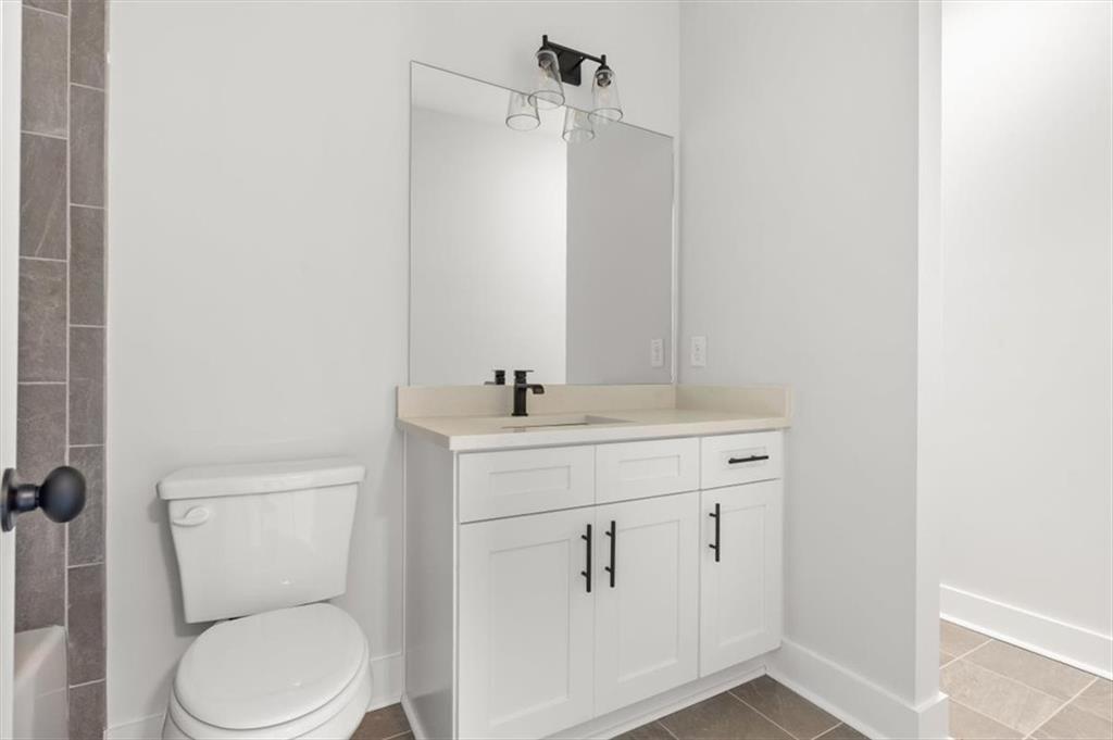 30 Rushden Way Southeast Rome, GA 30161 - Photo 38 of 58 a bathroom with a toilet sink vanity and mirror