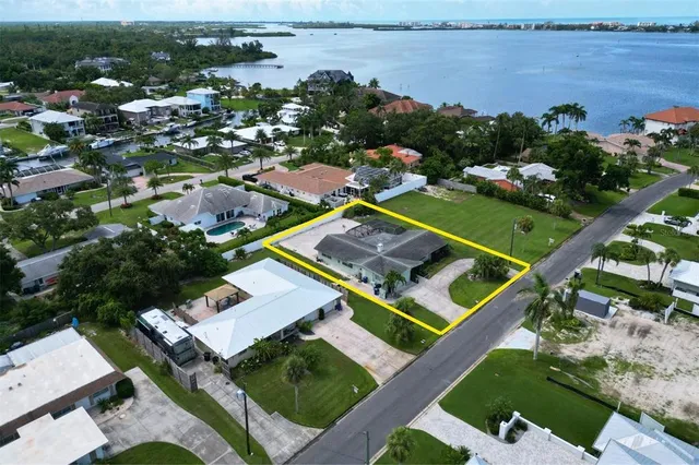 an aerial view of a house with a garden and lake view