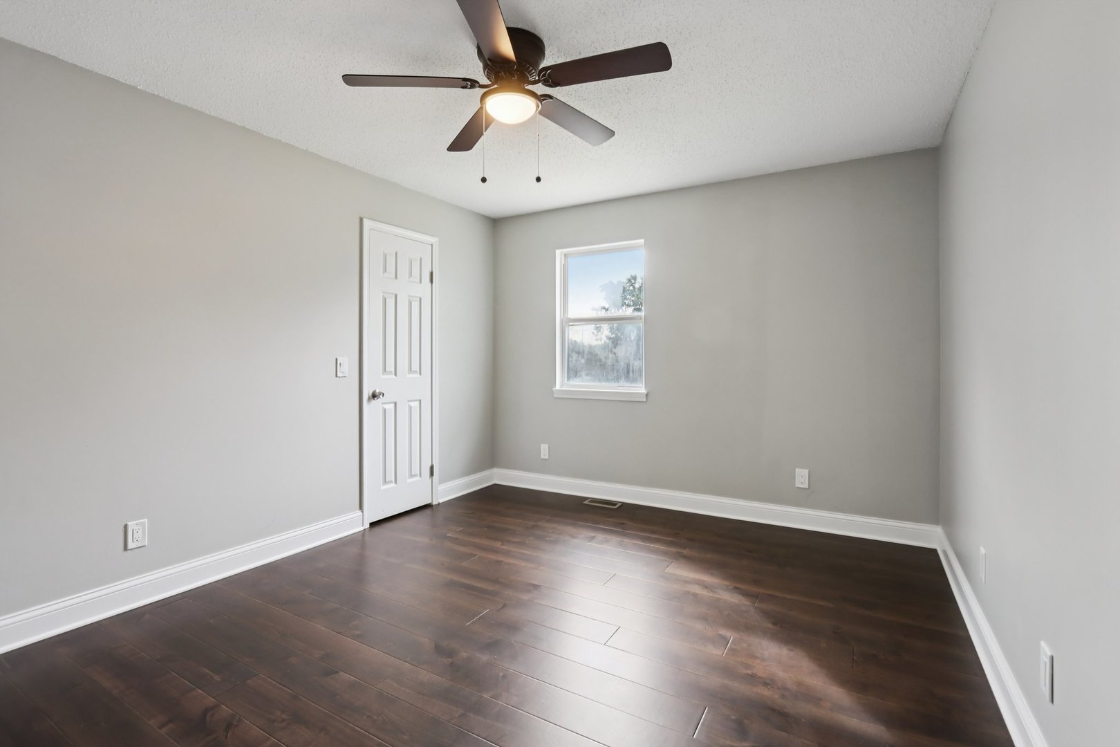 3103 Timberline Drive Champaign, IL 61822 - Photo 11 of 19 an empty room with wooden floor ceiling fan and windows
