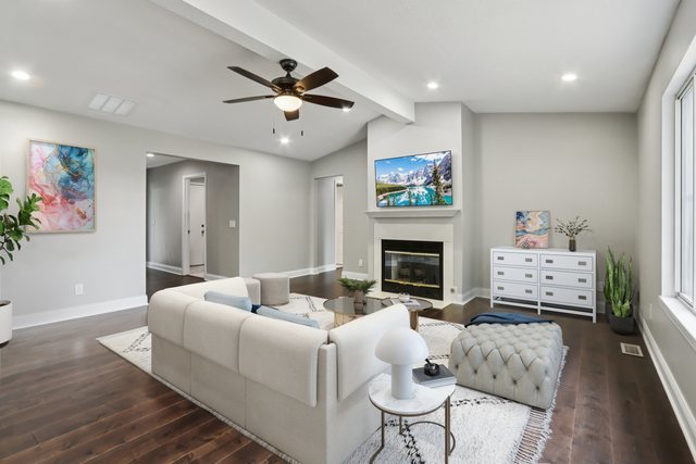 3103 Timberline Drive Champaign, IL 61822 - Photo 2 of 19 a living room with furniture a fireplace and a flat screen tv