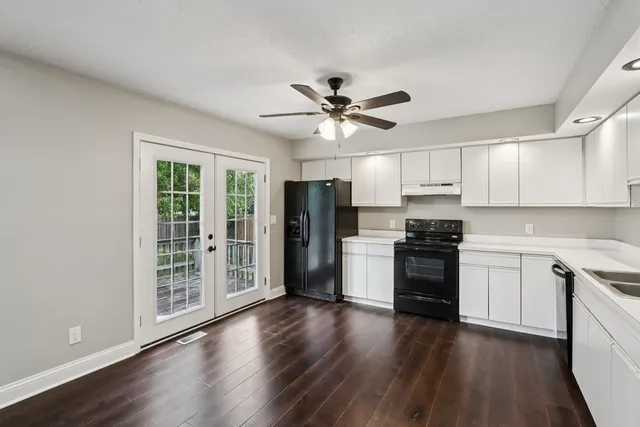 a kitchen with stainless steel appliances a stove a refrigerator a sink and a microwave