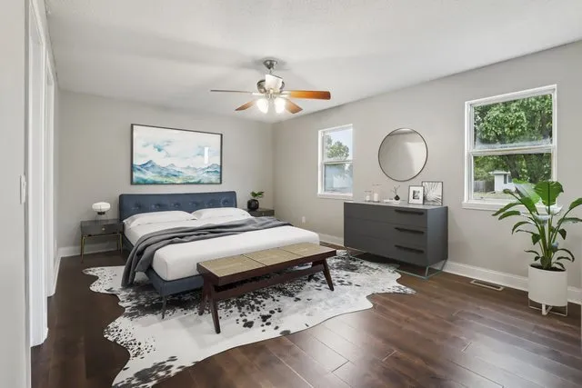 a bedroom with a bed window and a potted plant
