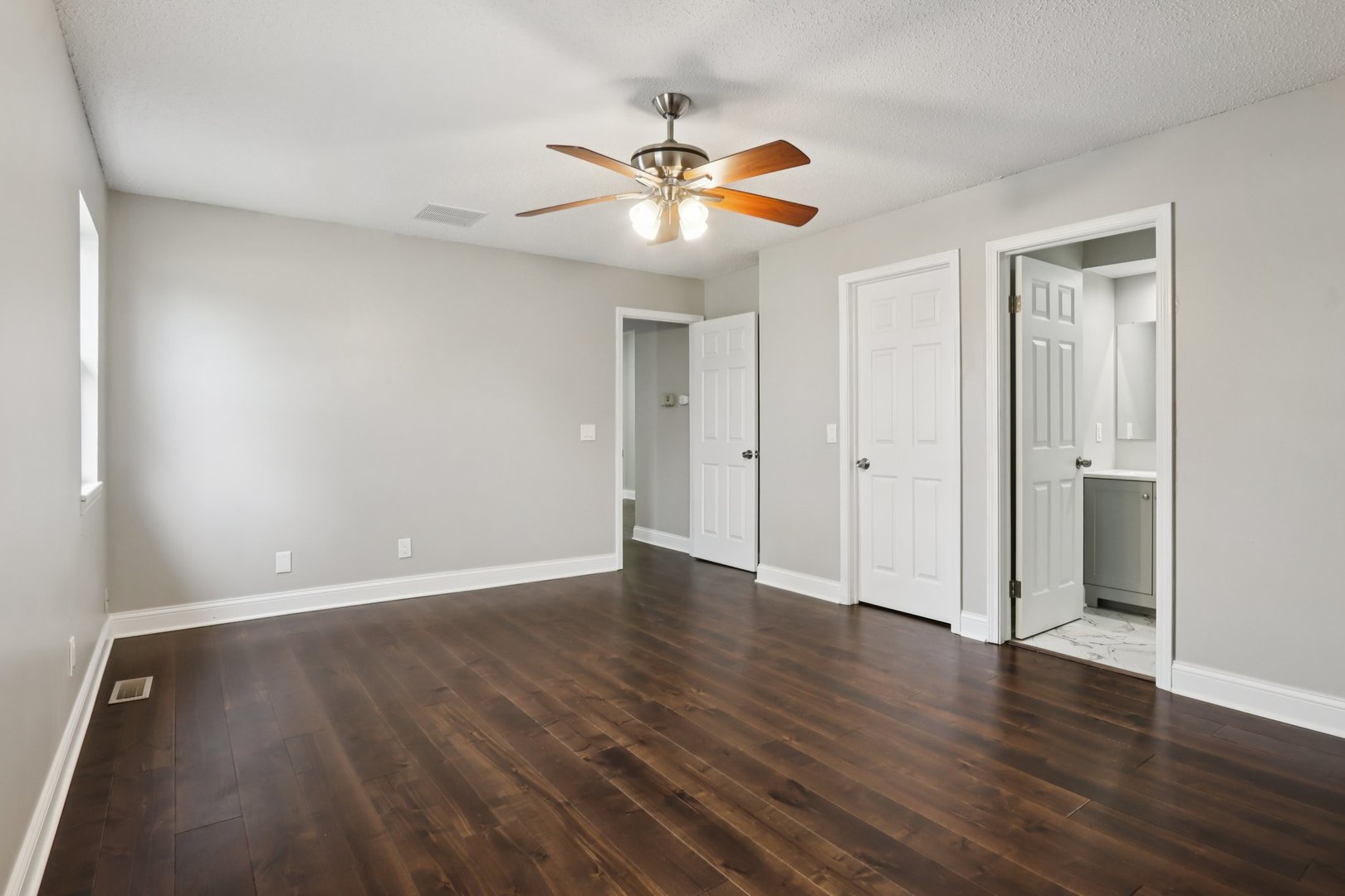 3103 Timberline Drive Champaign, IL 61822 - Photo 9 of 19 a view of an empty room with wooden floor and a ceiling fan