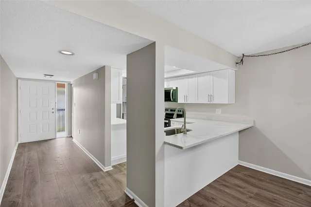 a kitchen with stainless steel appliances granite countertop a refrigerator and a sink