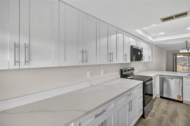 a kitchen with stainless steel appliances a refrigerator and a stove