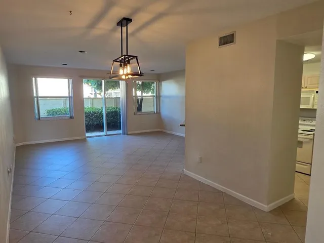 an empty room with windows and outdoor view