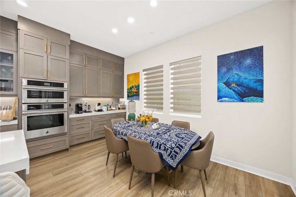478 Sycamore Montebello, CA 90640 - Photo 18 of 67 a kitchen with granite countertop a stove a sink dishwasher a dining table and chairs with wooden floor