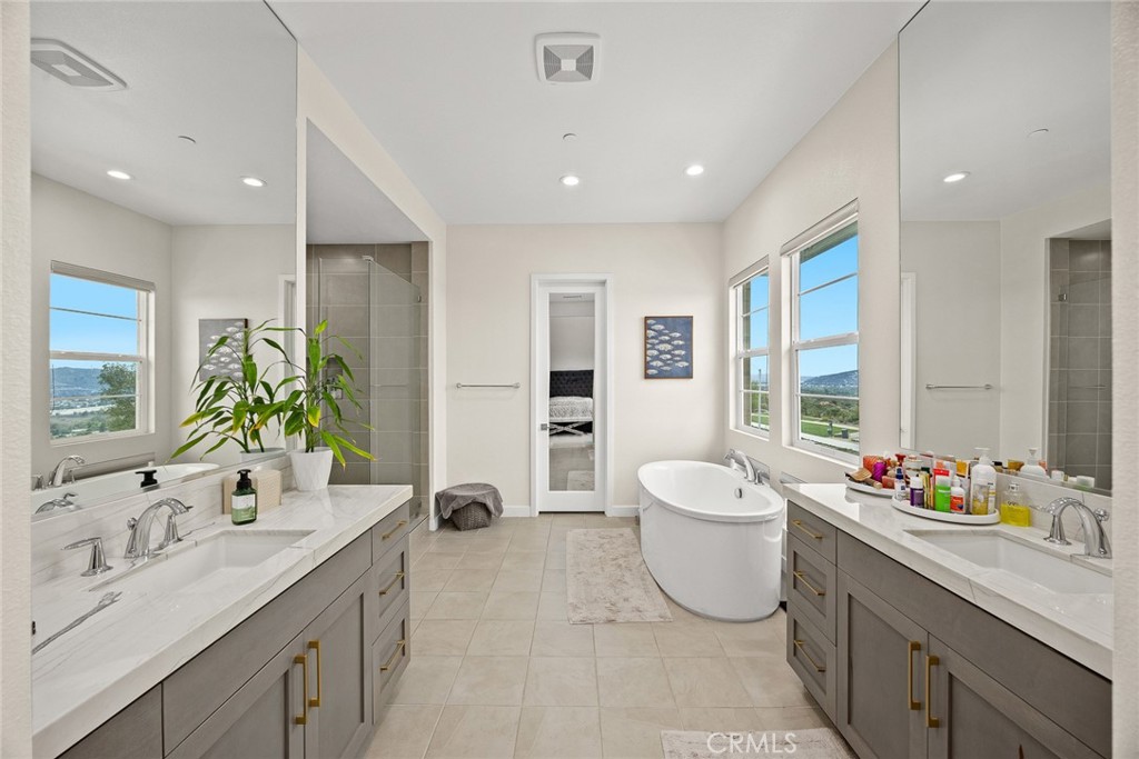 478 Sycamore Montebello, CA 90640 - Photo 29 of 67 a spacious bathroom with a double vanity sink a large mirror and a bathtub