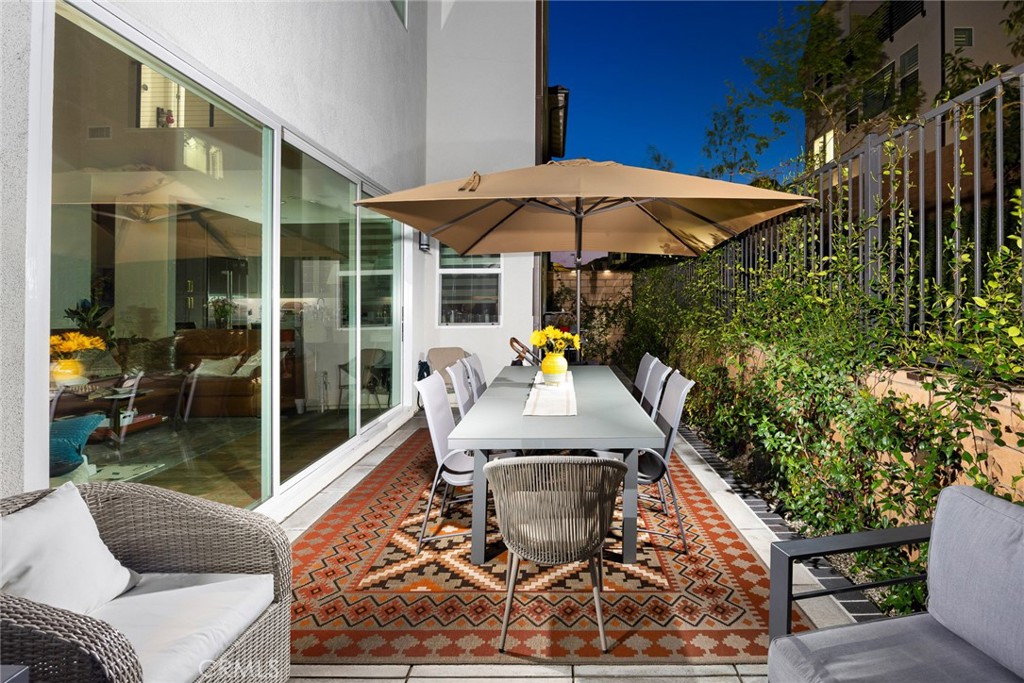 478 Sycamore Montebello, CA 90640 - Photo 40 of 67 a view of a patio with couches table and chairs under an umbrella