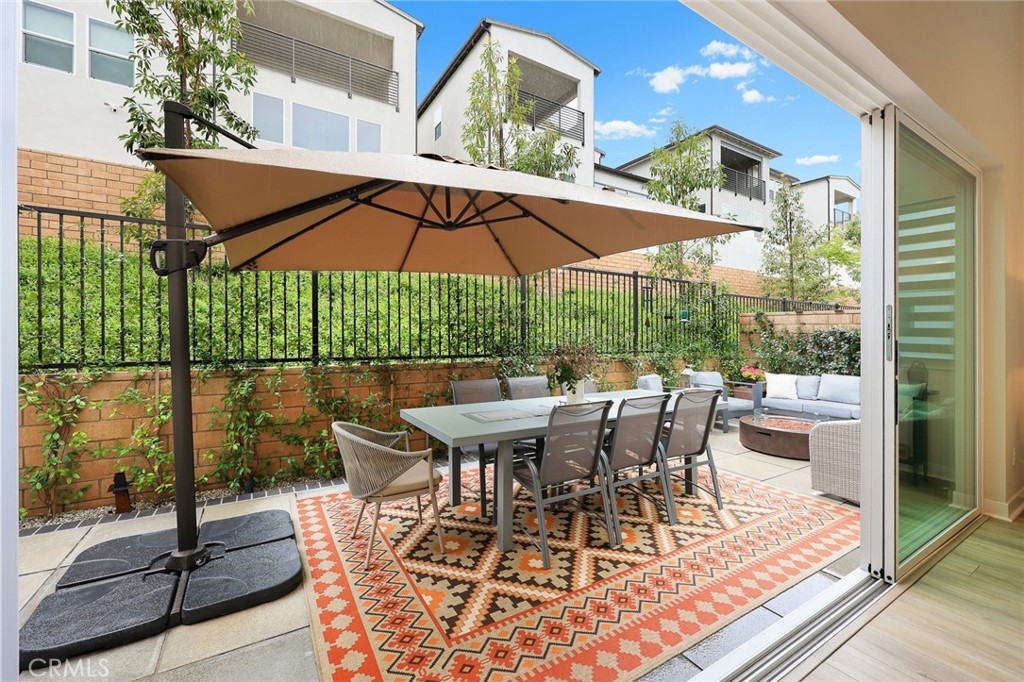478 Sycamore Montebello, CA 90640 - Photo 43 of 67 a view of a patio with table and chairs under an umbrella