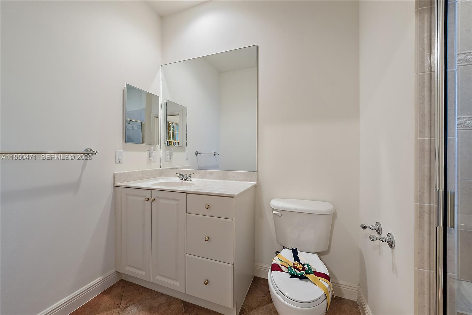 133 Mystic Lane Jupiter, FL 33458 - Photo 18 of 56 a bathroom with a sink mirror and vanity