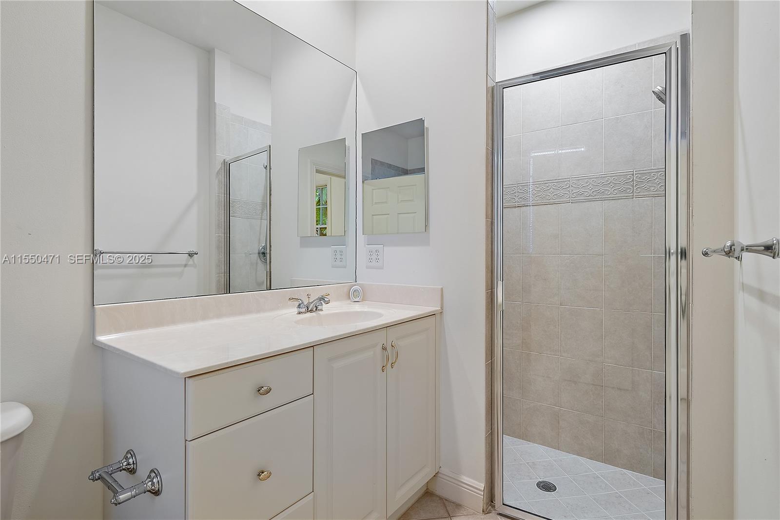 133 Mystic Lane Jupiter, FL 33458 - Photo 20 of 56 a bathroom with a sink and mirror