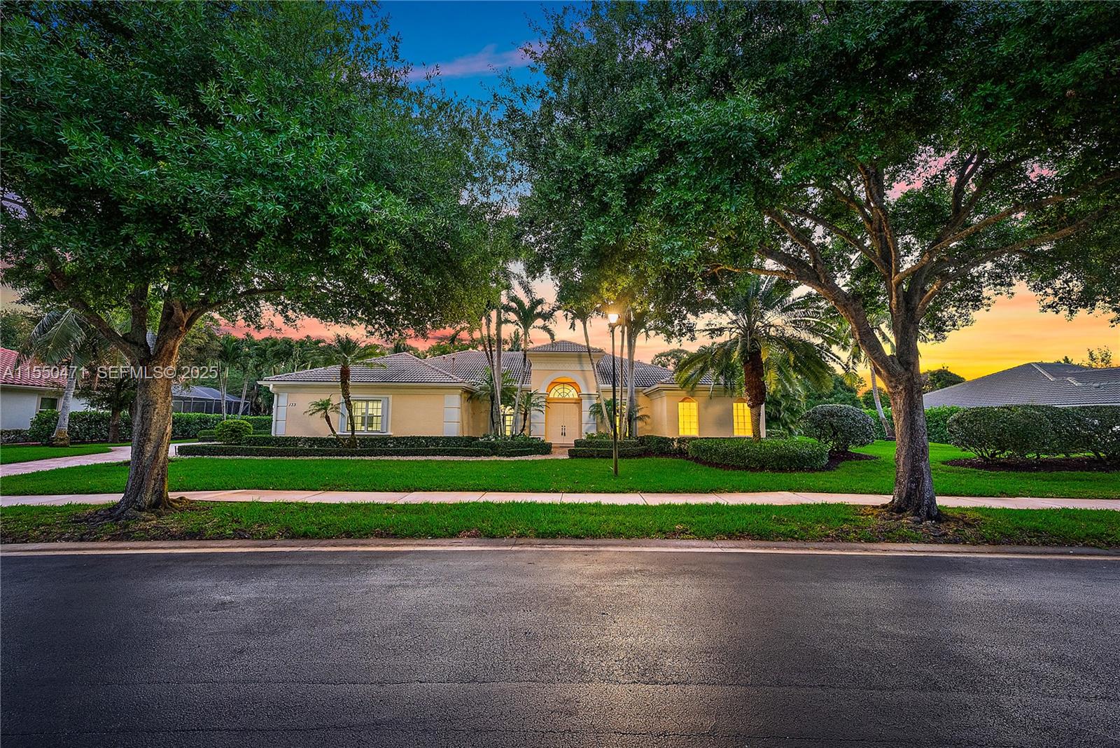 133 Mystic Lane Jupiter, FL 33458 - Photo 2 of 56 a front view of a house with a yard and trees