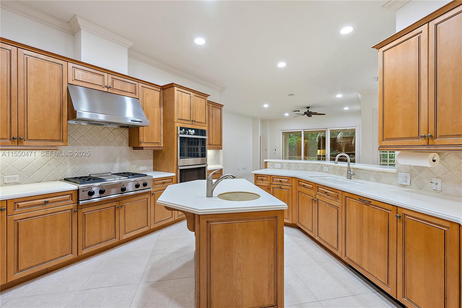 133 Mystic Lane Jupiter, FL 33458 - Photo 30 of 56 a kitchen with stainless steel appliances granite countertop a sink stove and cabinets