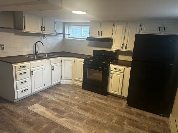 a kitchen with stainless steel appliances granite countertop a refrigerator sink and cabinets