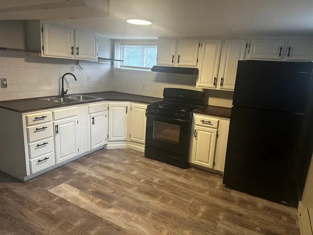 a kitchen with stainless steel appliances granite countertop a refrigerator sink and cabinets