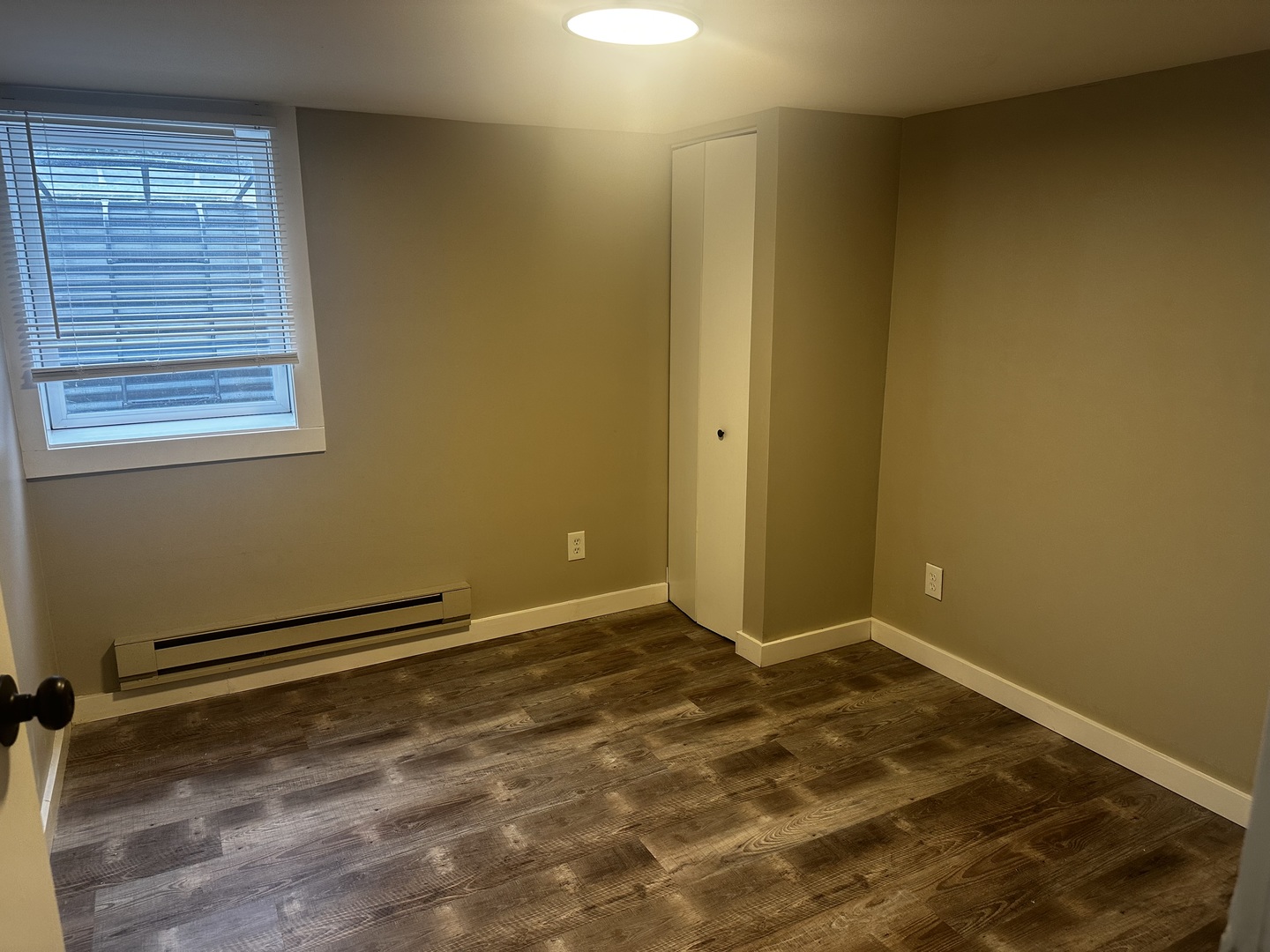 800 Ave B, Unit 1 Rochelle, IL 61068 - Photo 6 of 7 a view of a room with wooden floor and a window