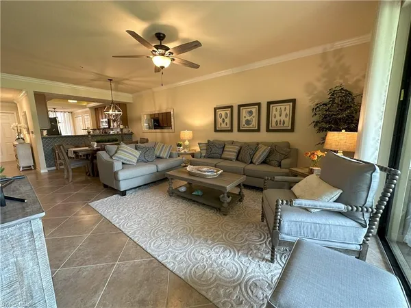a living room with furniture and a ceiling fan