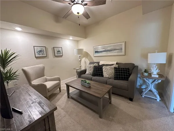 a living room with furniture and a chandelier