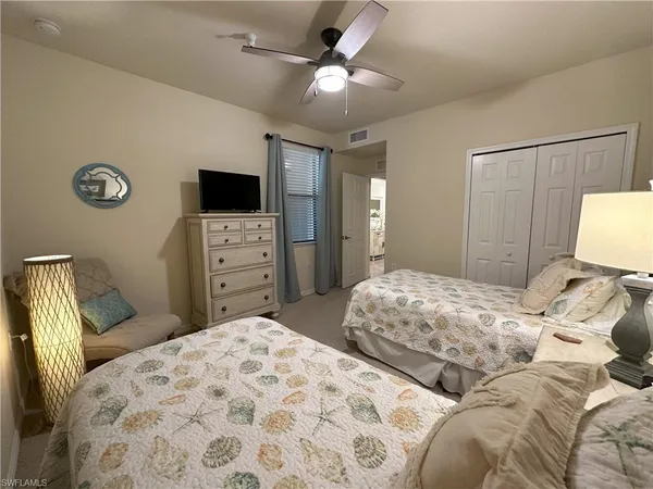 a bedroom with a bed and a tv