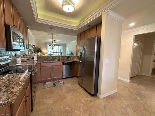a kitchen with stainless steel appliances granite countertop a refrigerator and a stove