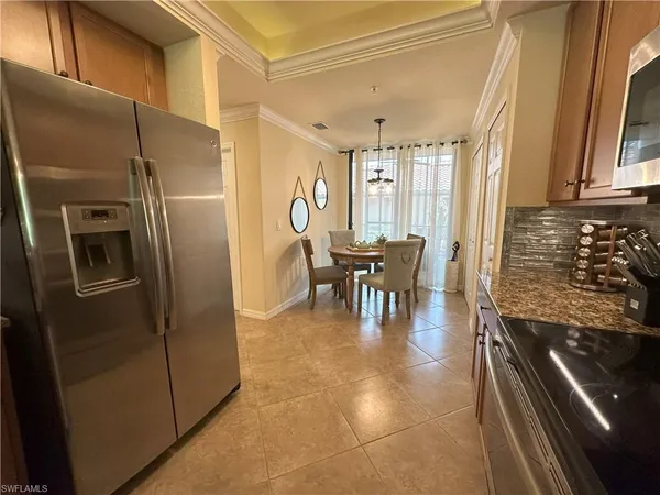 a kitchen with stainless steel appliances granite countertop a refrigerator and a stove