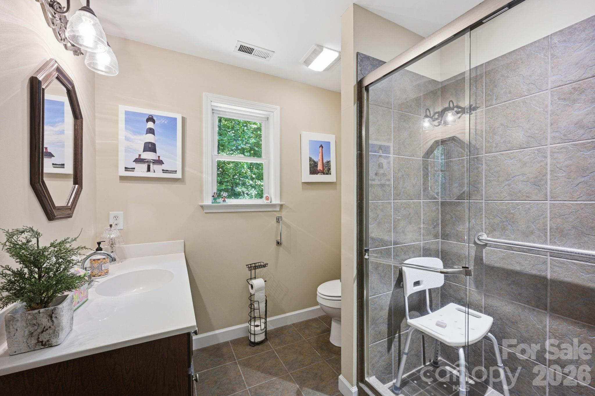 145 Upper Spencer Mountain Road Stanley, NC 28164 - Photo 24 of 29 a bathroom with a sink toilet and a mirror