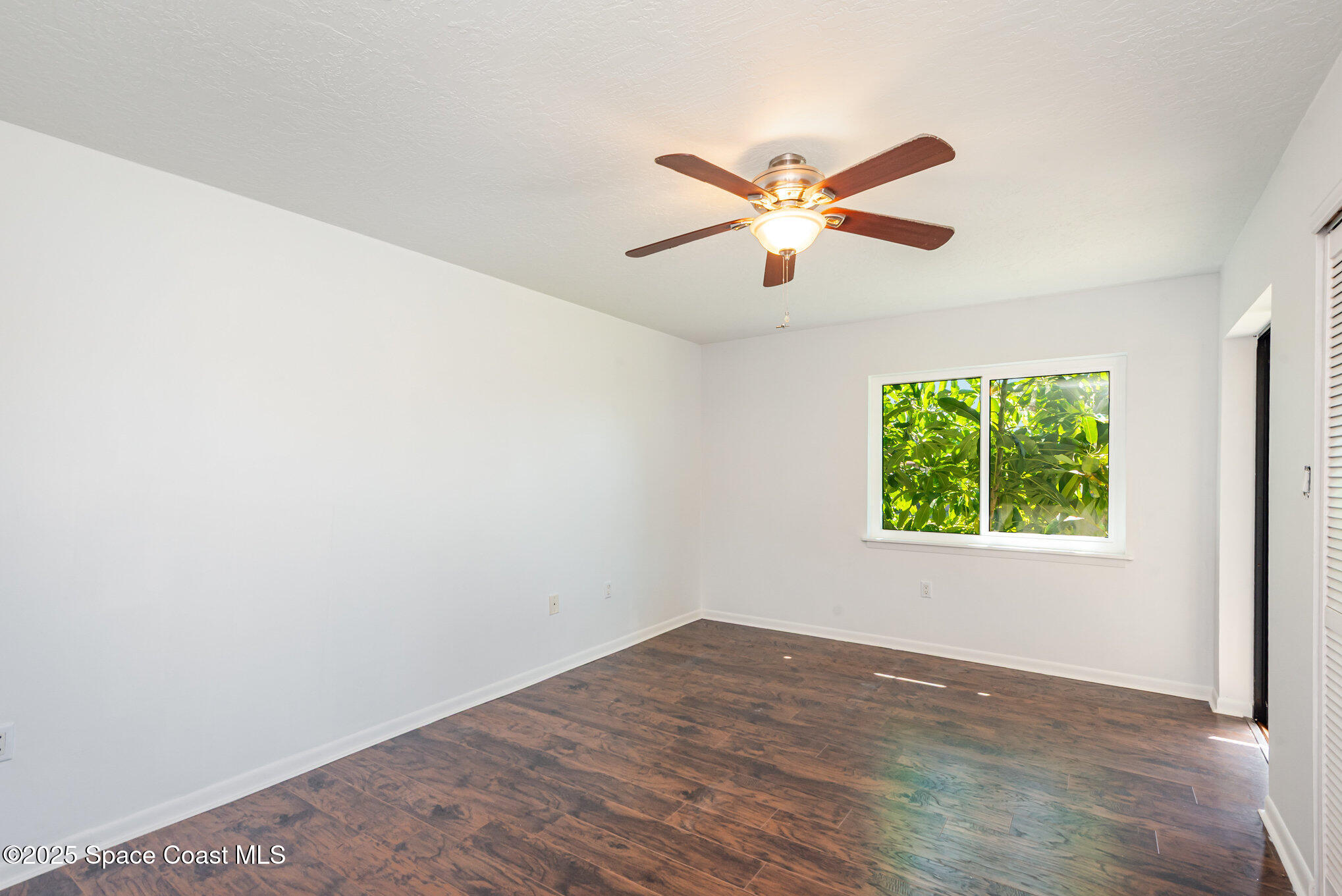 1515 Huntington Lane, Unit 427 Rockledge, FL 32955 - Photo 11 of 21 an empty room with a window and a fan