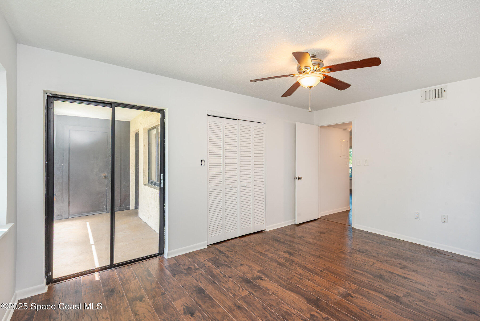 1515 Huntington Lane, Unit 427 Rockledge, FL 32955 - Photo 12 of 21 wooden floor in an empty room with a window