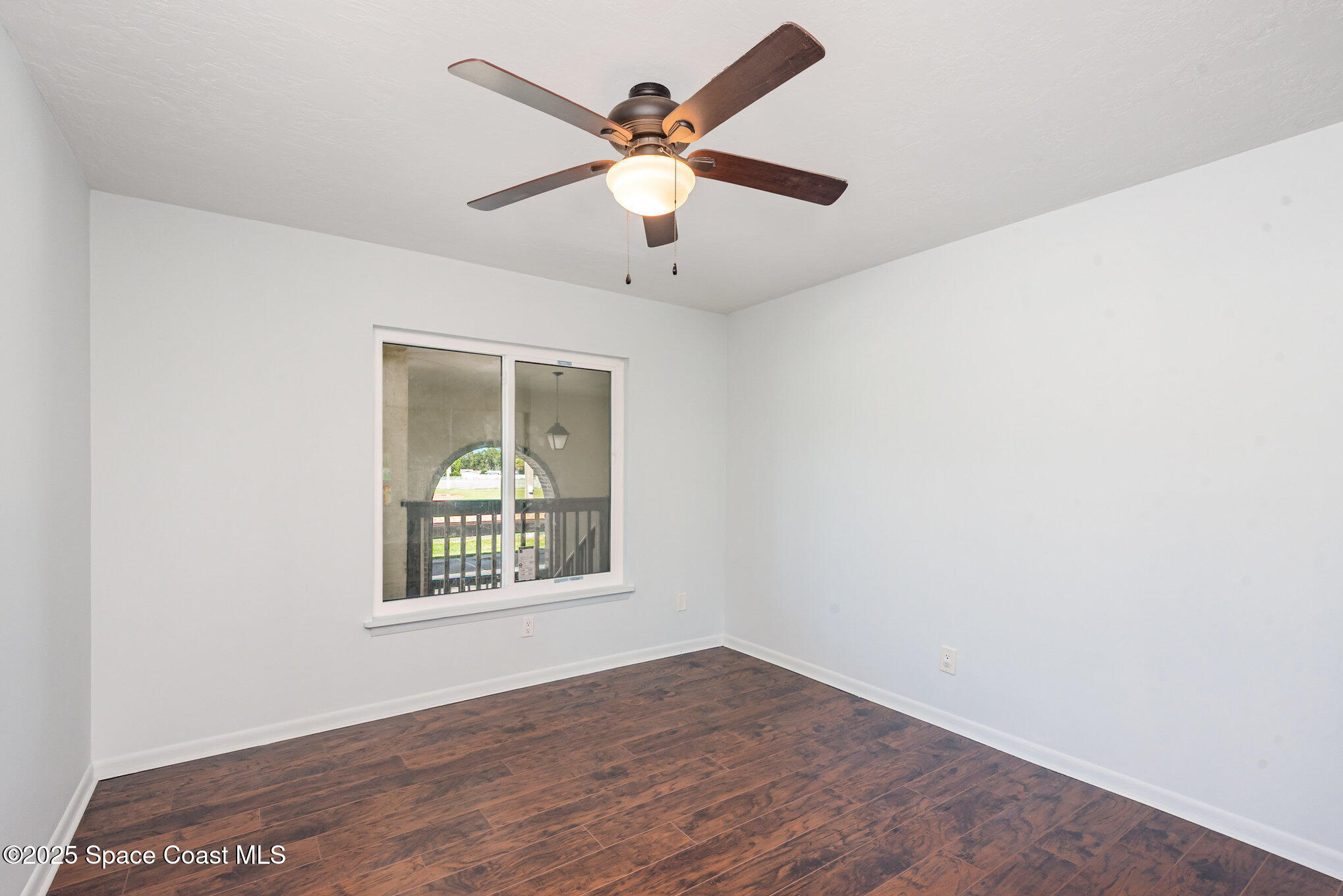 1515 Huntington Lane, Unit 427 Rockledge, FL 32955 - Photo 13 of 21 an empty room with window and ceiling fan