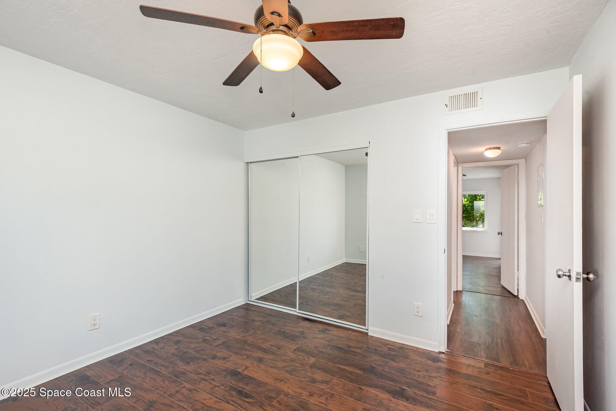 1515 Huntington Lane, Unit 427 Rockledge, FL 32955 - Photo 14 of 21 wooden floor in an empty room with a window