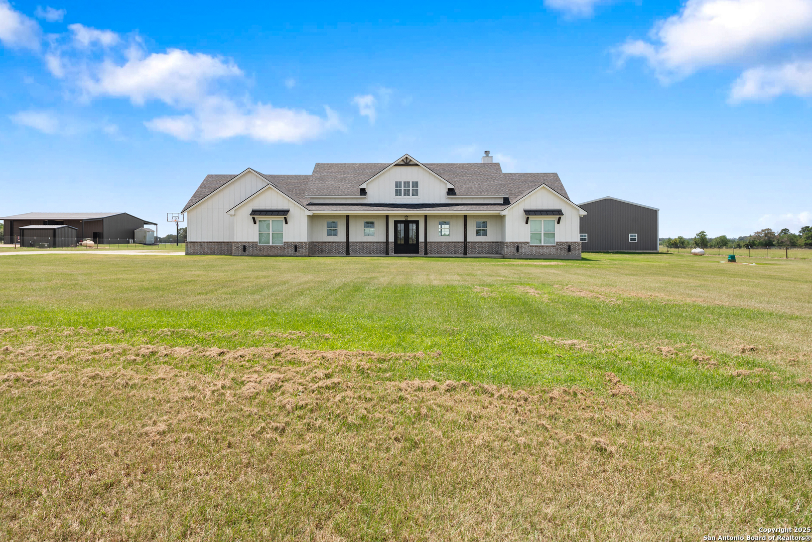 a front view of a house with a garden and deck